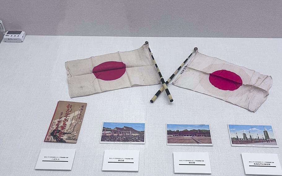 Japanese flags and old pictures on display at the Edo-Tokyo Open Air Architectural Museum.
